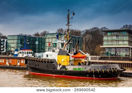 Tugboats Docked At The Hamburg Port On The Banks Of The Elbe River