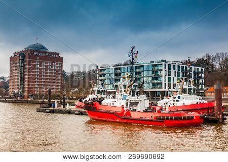 Tugboats Docked At The Hamburg Port On The Banks Of The Elbe River