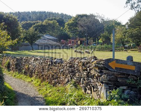 A Yellow Arrow Camino Waymark On A Dry-stone Wall - Ventas De Naron, Galicia, Spain, 30 September 20