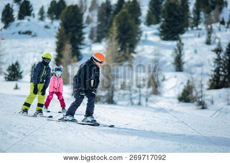 Winter Scene: A Group Of Children Are Learning To Ski