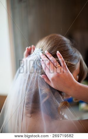 Close Up Bride Straightens Her Hair With A Veil, Back View