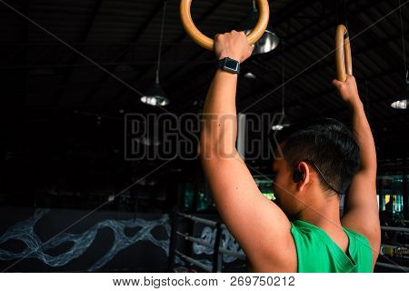 Asian Man Athlete Gymnast Rings Exercise In Gymnastics Exercise Chest 
Workout On Bench Press Cable 
