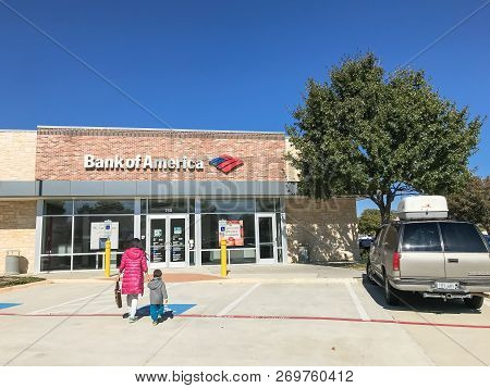 Bank Of American Branch Office With Flying American Flags And Customers Visiting