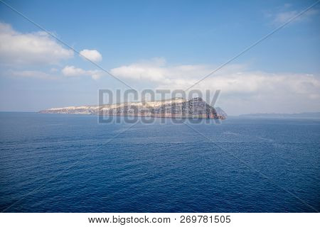 View Of Thirasia From Sea Next To Santorini In Greece
