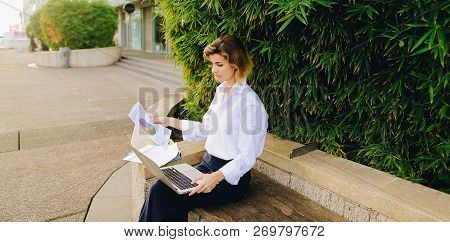 Statistician Working Outside With Laptop And Color Diagrams.