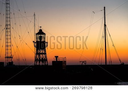 Abstract Photo With Industrial Character Of A Lighthouse Against A Brightly Colored Sky With Beautif