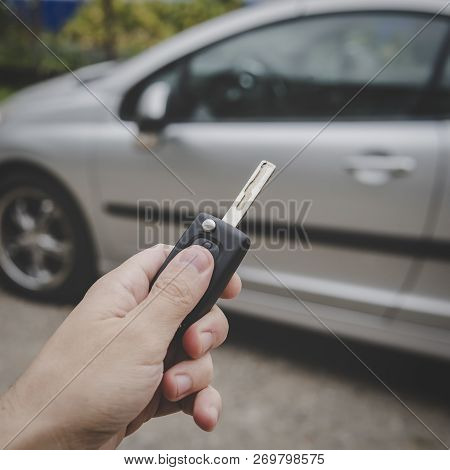 Man Opens His Car Door With The Control Remote Key. Male Hand Presses On The Vehicle Remote Control 