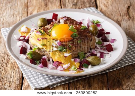 Delicious Danish Pariserbof Served With Raw Egg Yolk, Mustard And Vegetables Close-up On A Plate. Ho
