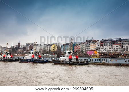 Tugboats Docked At The Hamburg Port On The Banks Of The Elbe River