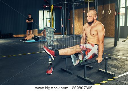 Sportsman With Prosthesis Working Out In Gym