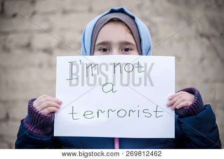 Refugee Girl With An Inscription On A White Sheet 