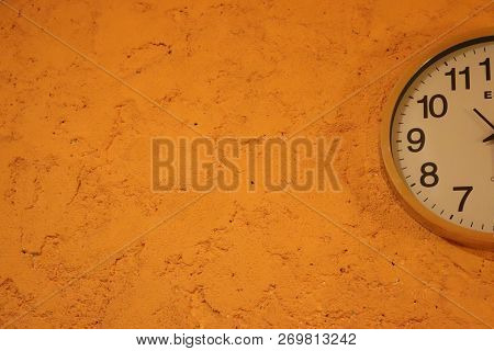 Clock. Semi-circle. Orange Wall Background, Number, Hours.