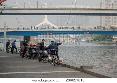 Tianjin, China - 21 October 2018: Local Fishermen By Tientsin Eye Ferris Wheel In Tianjin