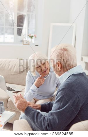 Elderly Beaming Couple On The Sofa In A Room