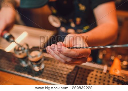 Bartender Making Shots On Black Bar With Reflection.
