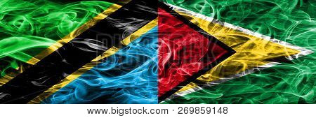 Tanzania Vs Guyana, Guyanese Smoke Flags Placed Side By Side. Thick Colored Silky Smoke Flags Of Tan