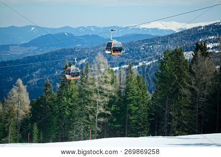 Orange Gondola Cabins Of Cableway Lift On Winter Snowy Mountains Background Beautiful Scenery