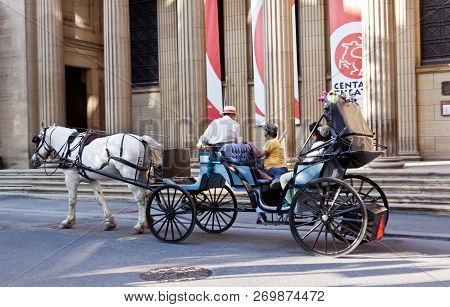 Montreal, Quebec, August 30, 2017 - Horizontal A Caliche Riders Going By The Historic Architecture O
