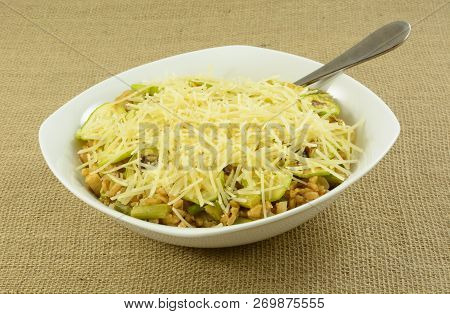 Serving Bowl Full Of Farro Wheat, Chicken Breast Meat, Chopped Asparagus With Shredded Cheese On Top
