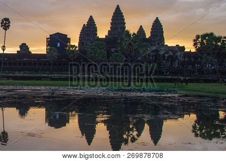 Golden Sky Form Sunrise View Of Ancient Temple Complex At Entrance Of Angkor Wat In Siem Reap, Cambo