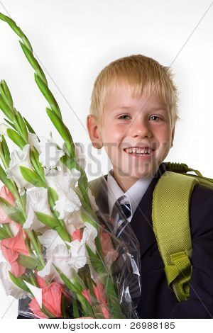 schoolboy with flowers and a backpack