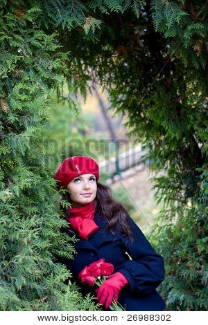 Girl with red roses in park