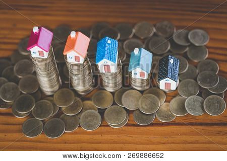 Mini House On Stack Of Coins,money And House,  Mortgage, Savings Money For Buy House And Loan To Bus