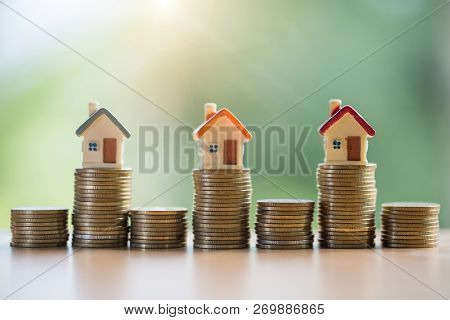 Mini House On Stack Of Coins,money And House,  Mortgage, Savings Money For Buy House And Loan To Bus