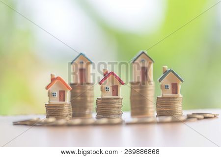 Mini House On Stack Of Coins,money And House,  Mortgage, Savings Money For Buy House And Loan To Bus