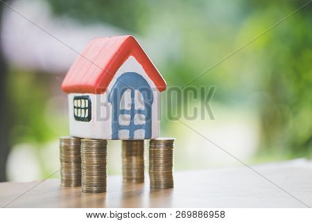 Mini House On Stack Of Coins,money And House,  Mortgage, Savings Money For Buy House And Loan To Bus