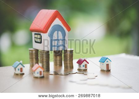 Mini House On Stack Of Coins,money And House,  Mortgage, Savings Money For Buy House And Loan To Bus