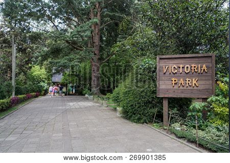 Nuwara Eliya, Sri Lanka - August 6, 2018: Signpost And People On A Path In Victoria Park