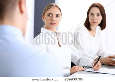 Group Of Business People Or Lawyers Discussing  Terms Of Transaction In Office. Colleagues Working A