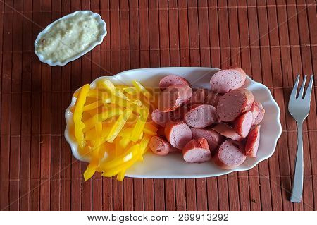 Viennese Sausages With Yellow Peppers Cut Into Strips As French Fries Substitutes. Low Carb Food