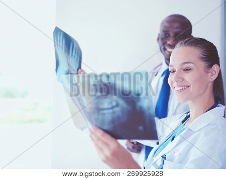 Doctors analyzing an x-ray in a meting. Doctors