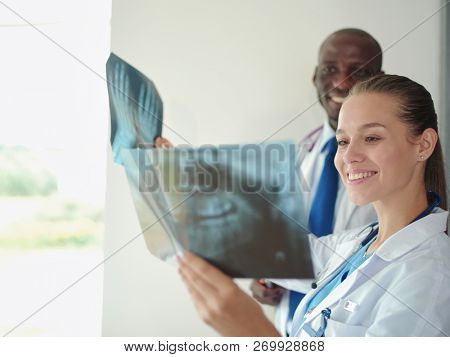 Doctors analyzing an x-ray in a meting. Doctors