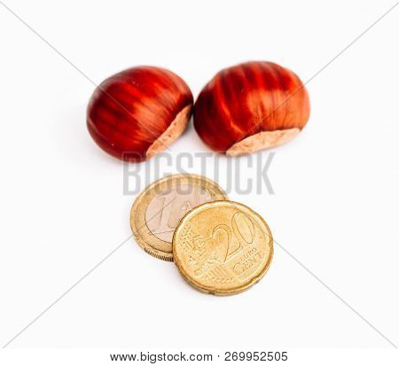 Two Roasted Chestnuts In A Pile, Isolated On White Background. One Euro And Twenty Cents Coins, Sell