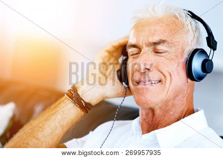 Handsome gray haired senior man with headphones