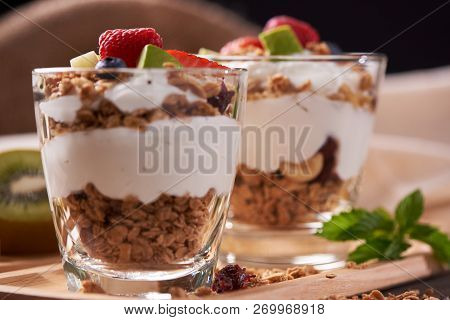 Two Glasses Of Delicious Yogurt And Fruits Including Strawberries, Kiwi, Blueberry Ontop For Health 