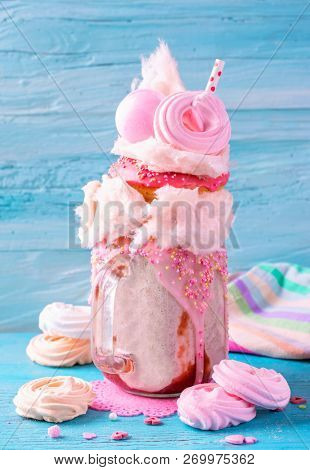 Strawberry freakshake with donuts and candy floss