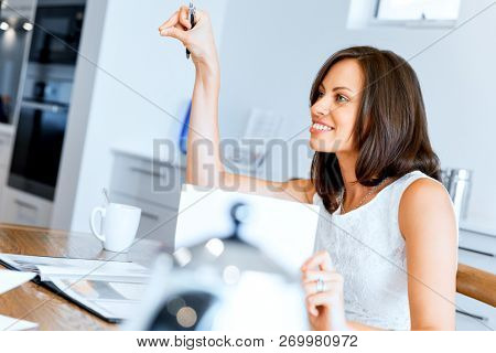 Woman with papers in their living room