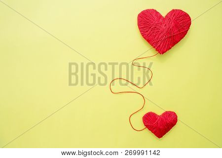 Red Heart Shape Symbol Made From Wool Isolated On Yellow Background.heart Shaped Woolen Yarn. Love C