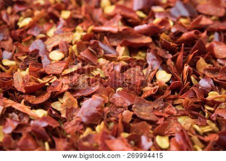Crushed red pepper, close-up, with depth. In realistic color. Shallow depth of field.
