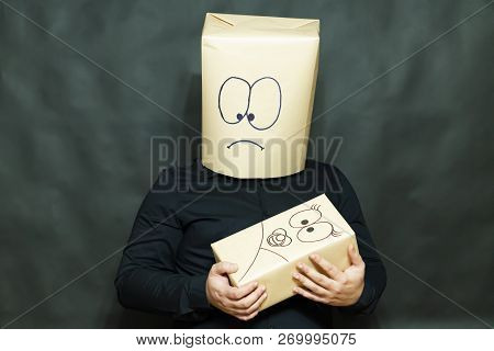 The Concept Of Emotions. The Man Is Holding A Small Child. The Face Expresses Surprise And Affection