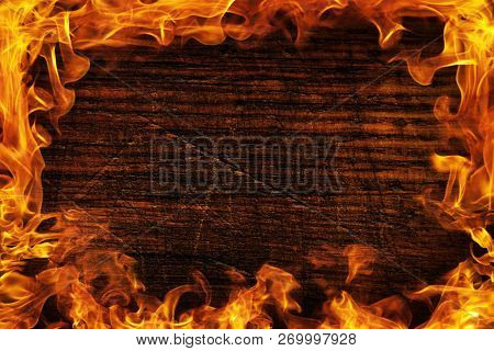 Texture Of Dark Wood And Frame Out Of The Fire. Wood Brown Texture Around The Burning Bright Flame. 