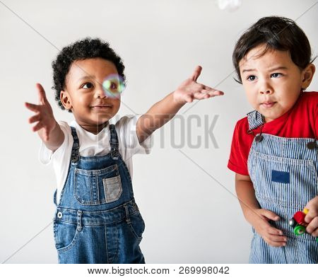 Two cute little boys enjoying playing with bubbles