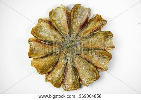 Dried Kradi Fish Fried In A Circular Pattern In White Background