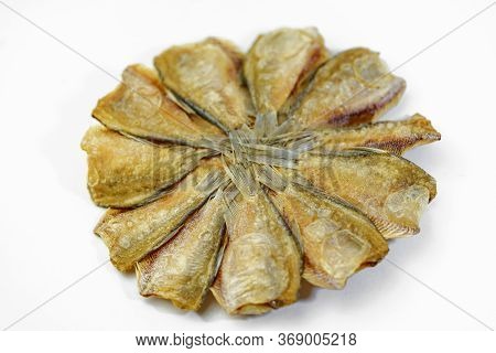 Dried Kradi Fish Fried In A Circular Pattern In White Background