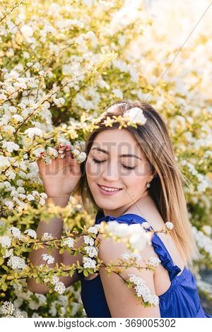 Sensual Calm Portrait Of Beautiful Hipster Woman In Blooming Bush With White Flowers Of Spirea. Copy