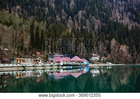 Cafe And House On The Shore Of Lake Ritsa In The Mountains In Abkhazia In The Spring. Panorama View